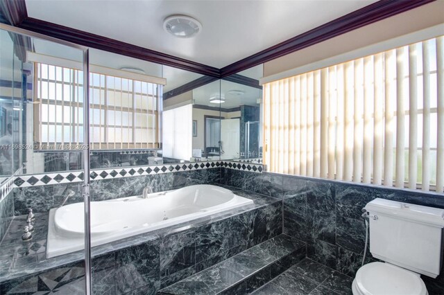 bathroom featuring toilet, a relaxing tiled tub, and ornamental molding