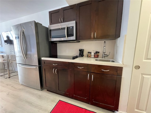 kitchen featuring light hardwood / wood-style floors, sink, and stainless steel appliances