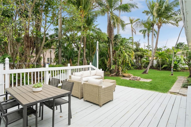 wooden deck featuring outdoor lounge area and a yard