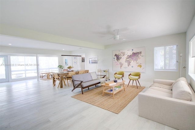 living room with ceiling fan and light wood-type flooring