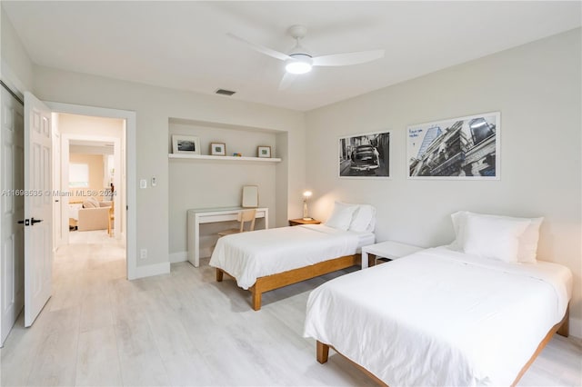 bedroom with light hardwood / wood-style flooring and ceiling fan