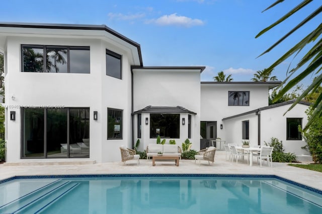 rear view of property with an outdoor hangout area and a patio