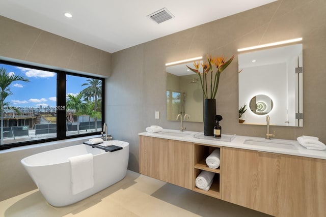 bathroom featuring vanity and a tub to relax in