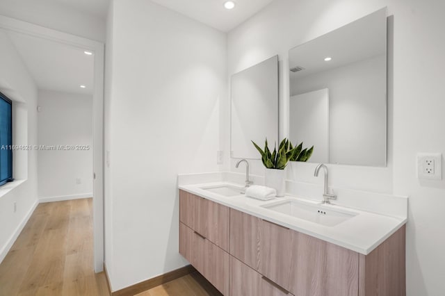 bathroom with vanity and wood-type flooring