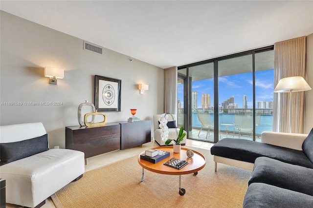 living room featuring a water view and expansive windows