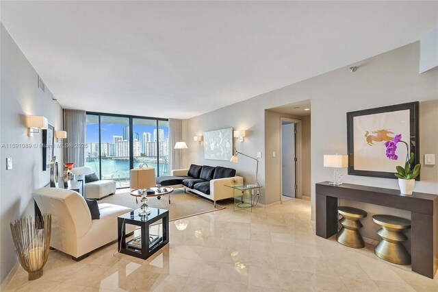 living room with floor to ceiling windows and a water view