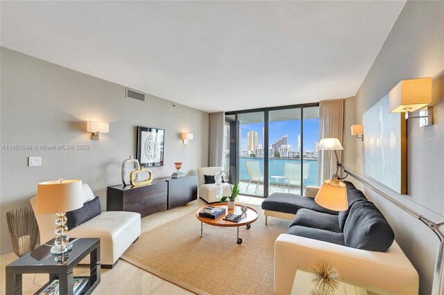 living room featuring a water view and expansive windows