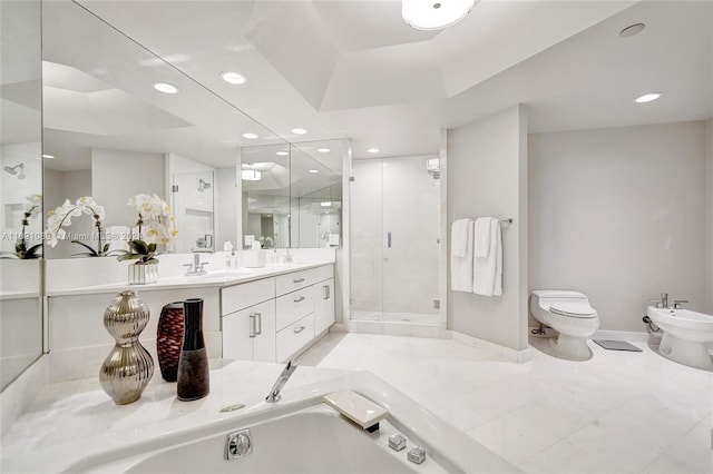 full bathroom featuring vanity, toilet, a bidet, and shower with separate bathtub