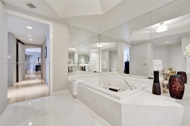 bathroom featuring tiled tub