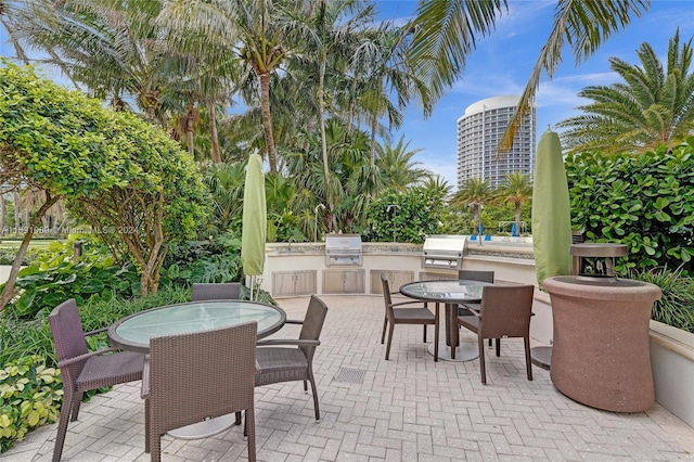 view of patio featuring area for grilling and a grill