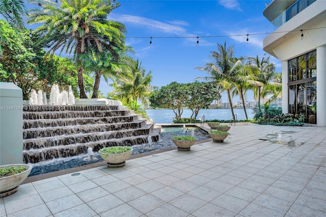 view of patio with a water view