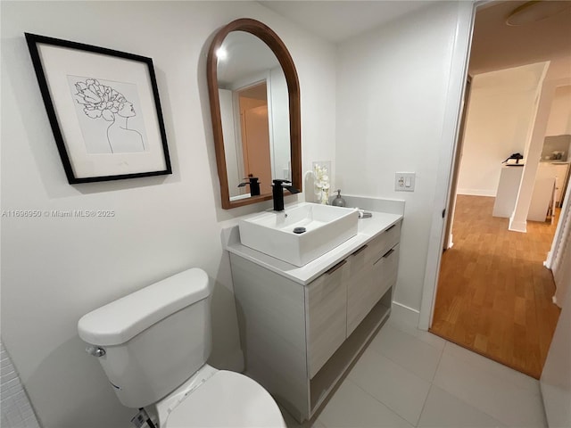 bathroom featuring tile patterned floors, vanity, and toilet