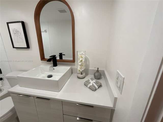 bathroom with toilet and vanity