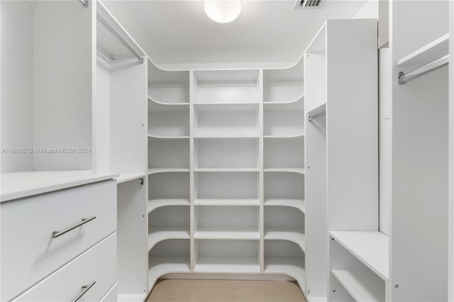 spacious closet with light tile patterned floors