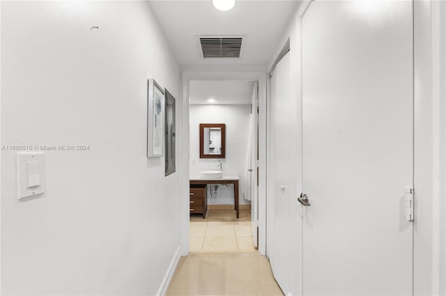 hall with light tile patterned floors