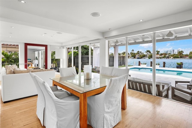 sunroom / solarium with a water view