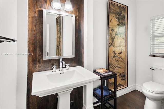 bathroom with hardwood / wood-style flooring and toilet