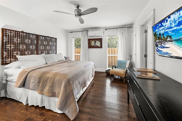 bedroom featuring dark hardwood / wood-style floors, a wall unit AC, and ceiling fan