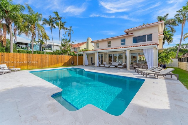 exterior space with a fenced in pool and a patio area