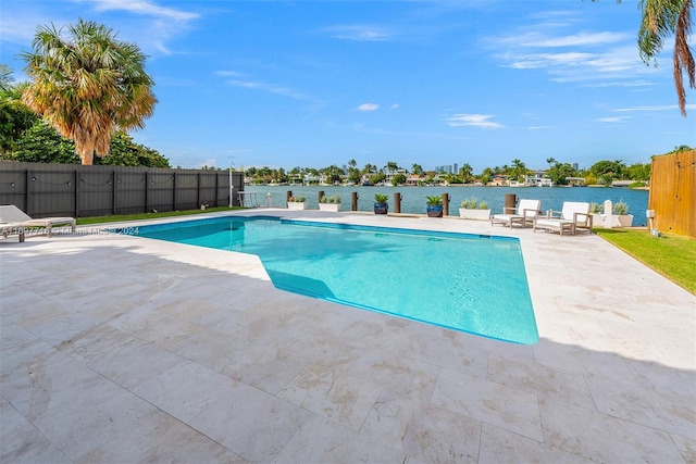 view of pool featuring a water view and a patio