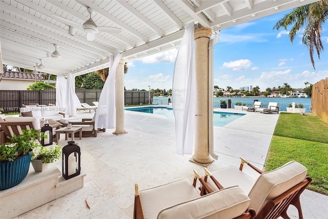 view of patio / terrace featuring an outdoor living space, ceiling fan, a water view, and a fenced in pool