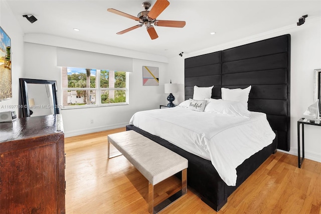 bedroom with ceiling fan and light hardwood / wood-style floors