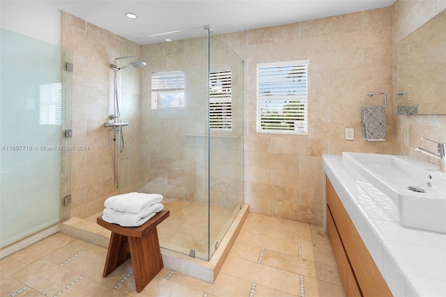 bathroom with sink, tile walls, and walk in shower