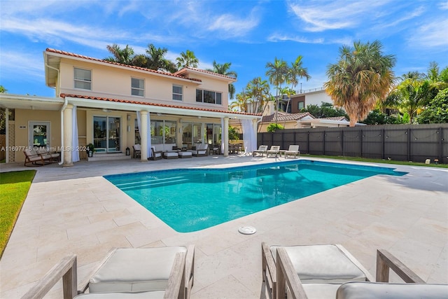 view of swimming pool with a patio, an outdoor hangout area, and ceiling fan