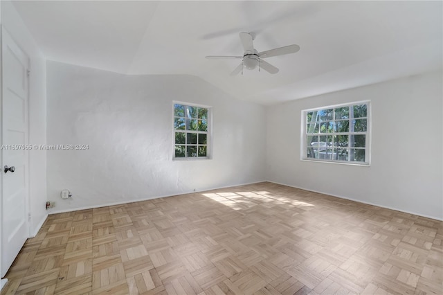 unfurnished room featuring ceiling fan, vaulted ceiling, and light parquet floors