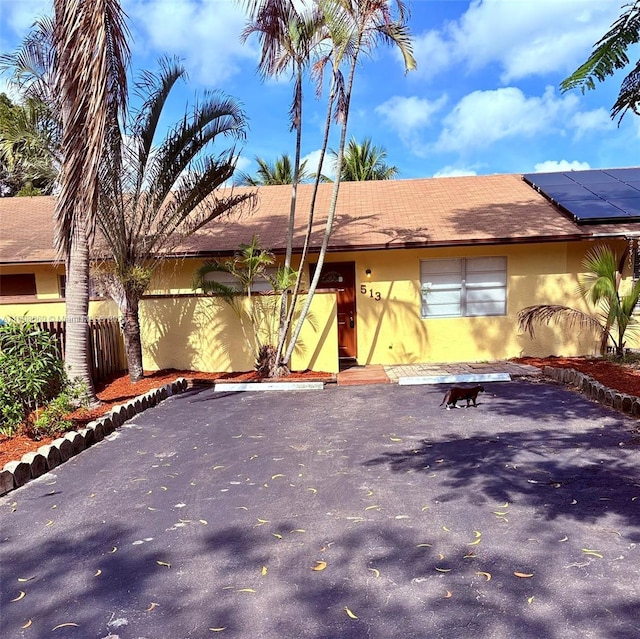 ranch-style home with solar panels