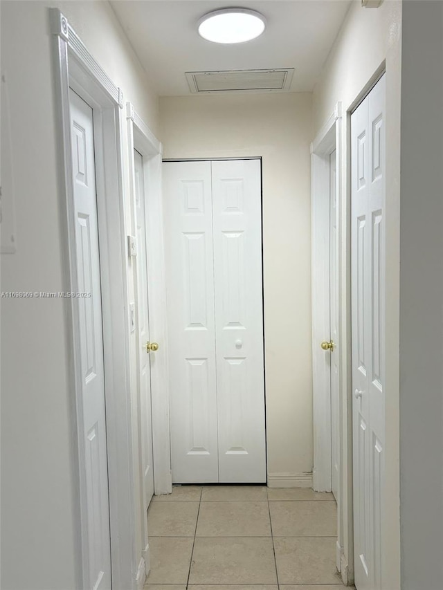 corridor featuring light tile patterned floors