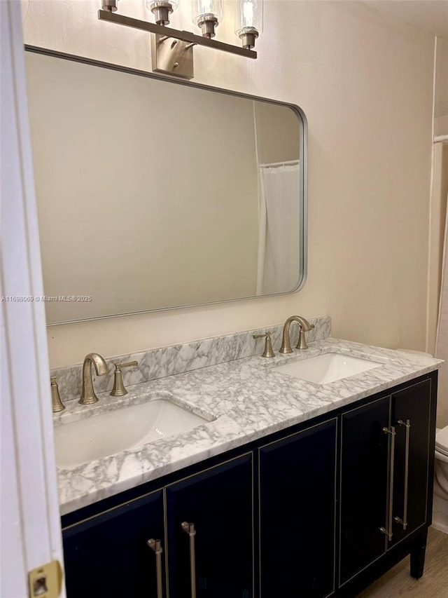 bathroom featuring vanity, hardwood / wood-style floors, toilet, and a shower with shower curtain