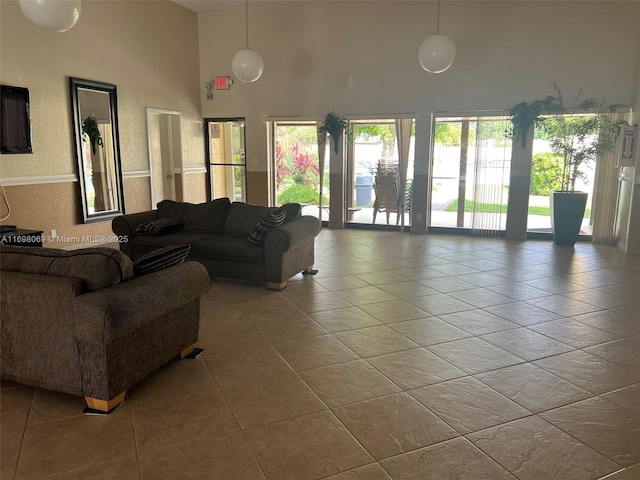 tiled living room featuring a high ceiling