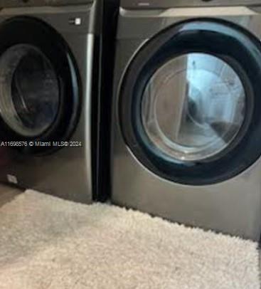 laundry room with washer / dryer