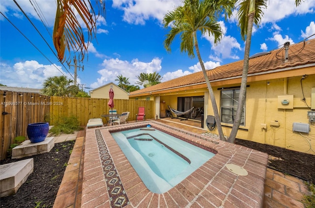 view of swimming pool featuring a patio area and an outdoor hot tub