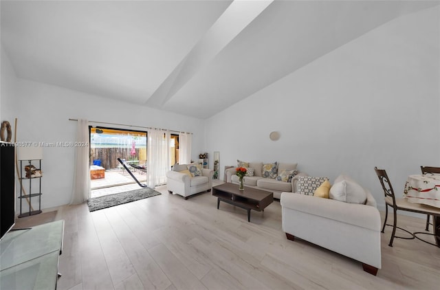 living room featuring light hardwood / wood-style floors and lofted ceiling