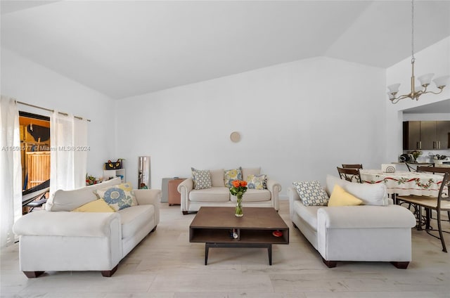 living room with a chandelier and lofted ceiling