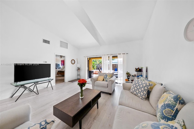 living room featuring light hardwood / wood-style flooring and high vaulted ceiling