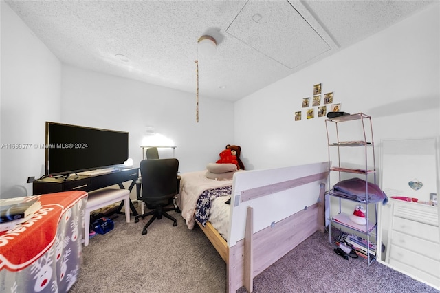 bedroom with carpet flooring and a textured ceiling