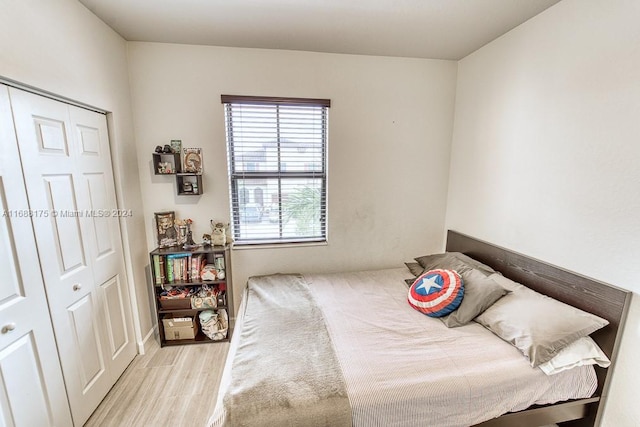 bedroom featuring light hardwood / wood-style flooring and a closet