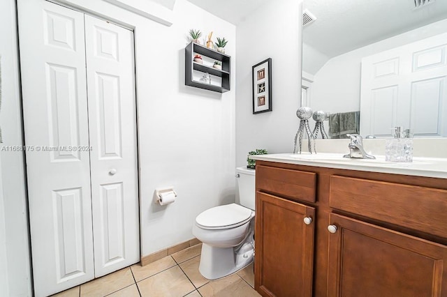 bathroom with tile patterned flooring, vanity, and toilet