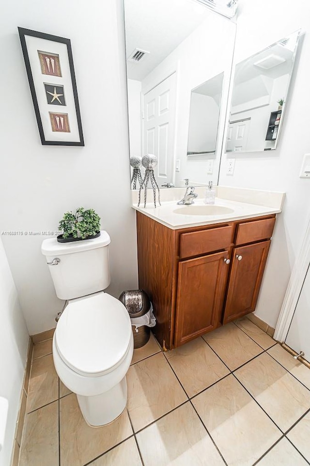 bathroom featuring tile patterned floors, vanity, and toilet