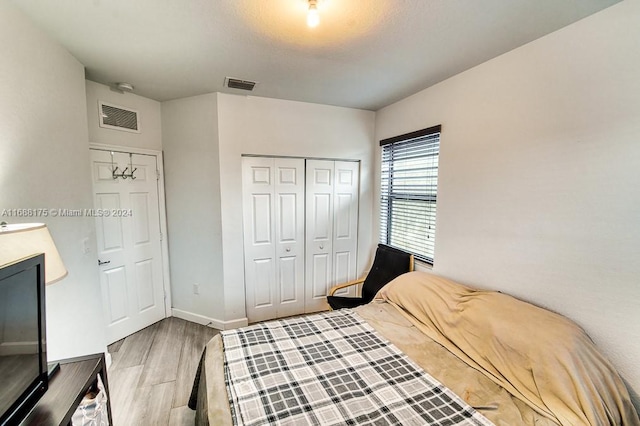 bedroom featuring light wood-type flooring and a closet