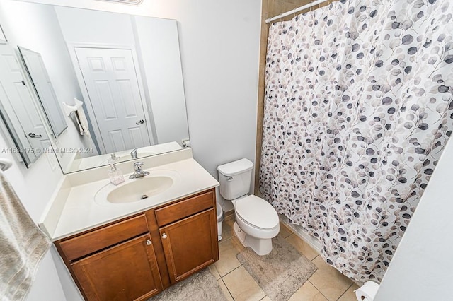 bathroom featuring tile patterned flooring, vanity, and toilet