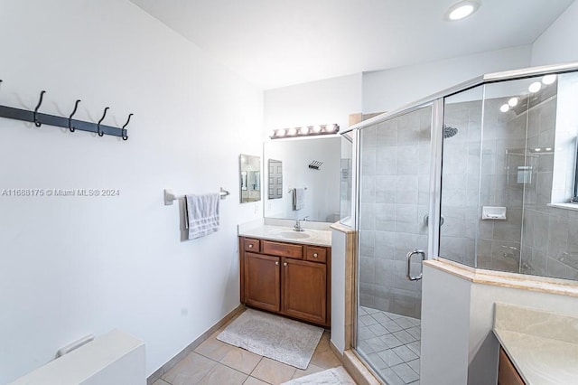 bathroom with tile patterned flooring, vanity, and an enclosed shower