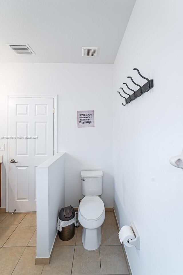 bathroom featuring toilet, vanity, and tile patterned floors