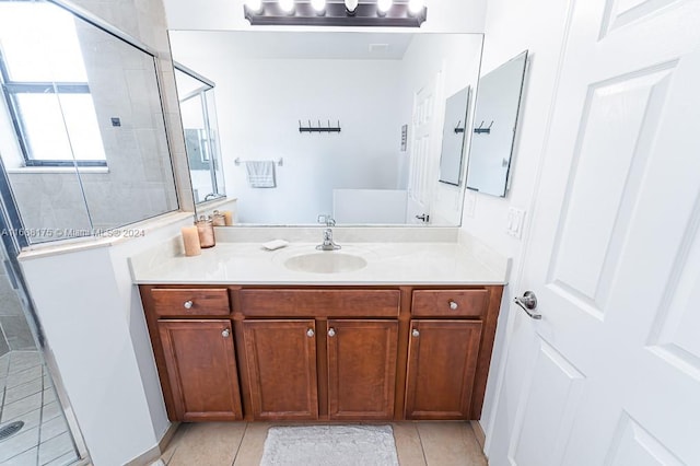 bathroom featuring vanity, tile patterned floors, and a shower with door