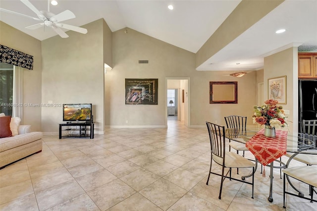 dining room with light tile patterned floors, high vaulted ceiling, and ceiling fan