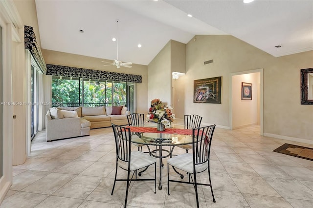 dining room with light tile patterned floors, high vaulted ceiling, and ceiling fan