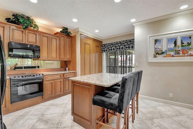 kitchen featuring a kitchen breakfast bar, a textured ceiling, crown molding, black appliances, and a kitchen island